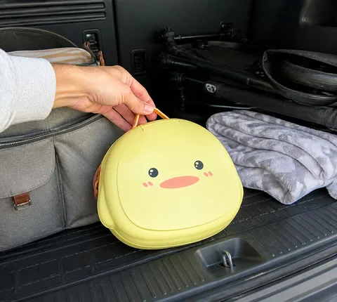 Folded yellow travel potty stored in a family minivan