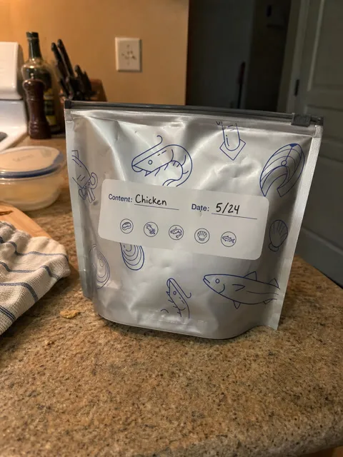 Labeled foil food storage bag standing on a home kitchen counter