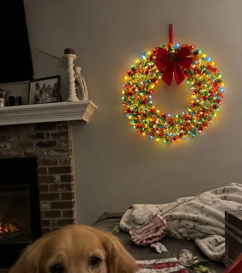 Glowing multicolor wreath in a lived-in family room after gift wrapping