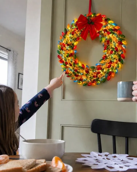 Child admiring the colorful wreath in a family breakfast nook