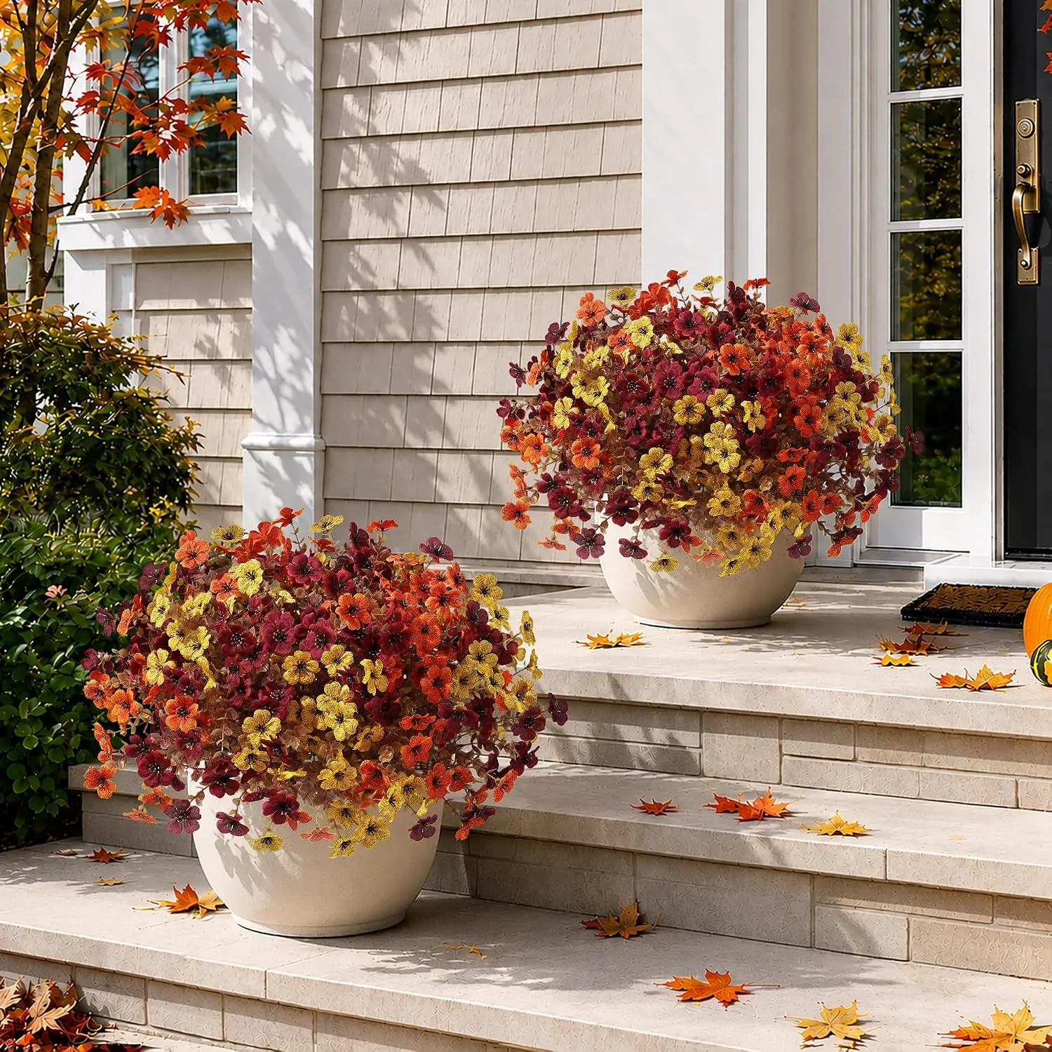 Two full artificial fall flower arrangements on front steps