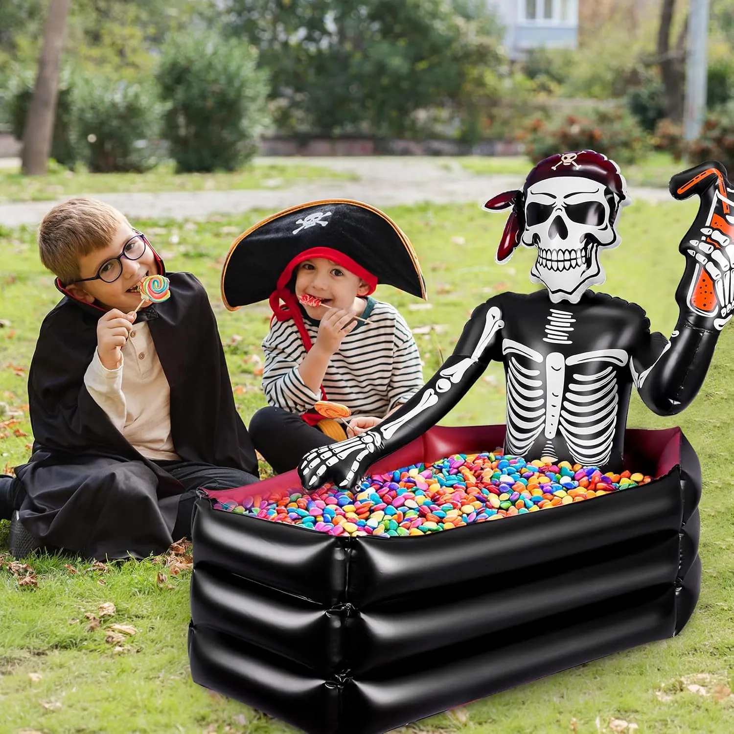 Children beside a pirate skeleton cooler filled with wrapped candy