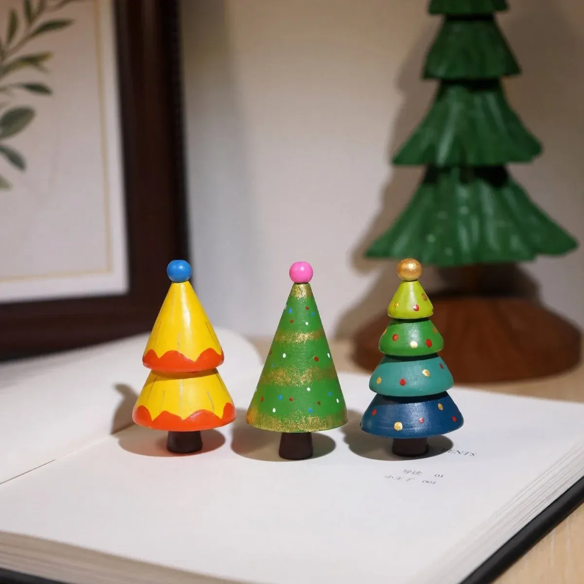 Customer photo of painted mini wooden trees on a book