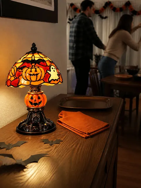 Pumpkin lamp on a sideboard during Halloween party setup