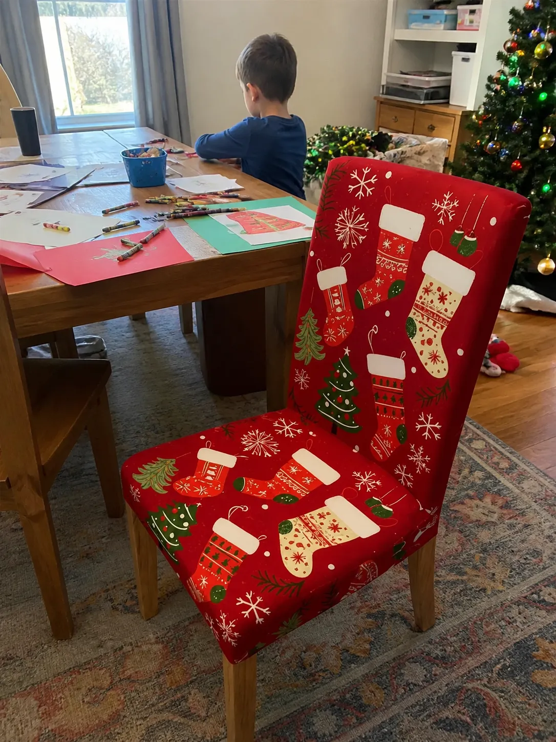 Christmas chair cover near a family craft table