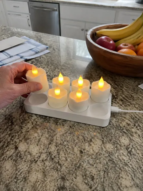 Rechargeable candles being returned to their base on a kitchen counter