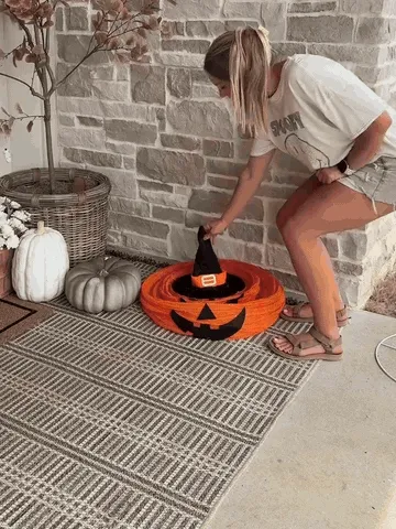 Three pumpkin lanterns being assembled and illuminated