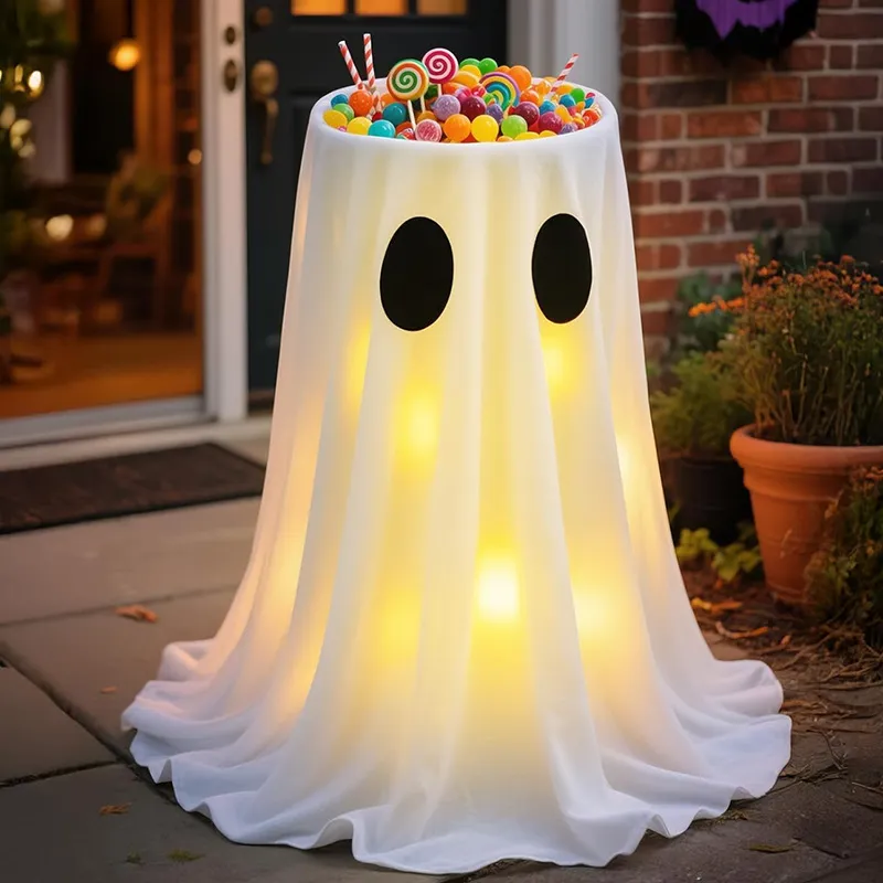 Light-up ghost candy bowl beside a brick porch entry