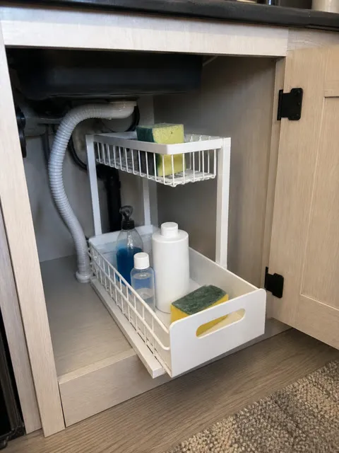 White organizer inside a compact RV sink cabinet