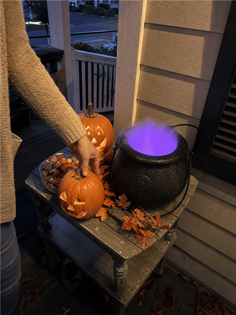 Casual customer porch display with a glowing cauldron