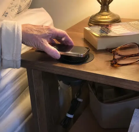 Phone charging on a bedroom nightstand