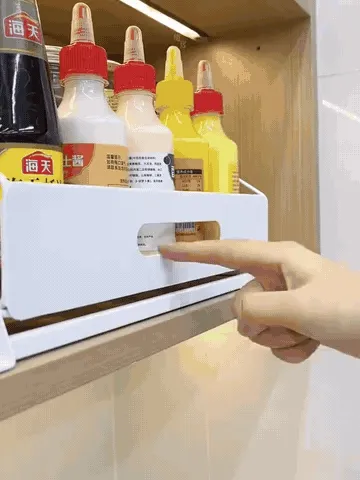 Pull-down cabinet spice rack moving from stored to accessible position