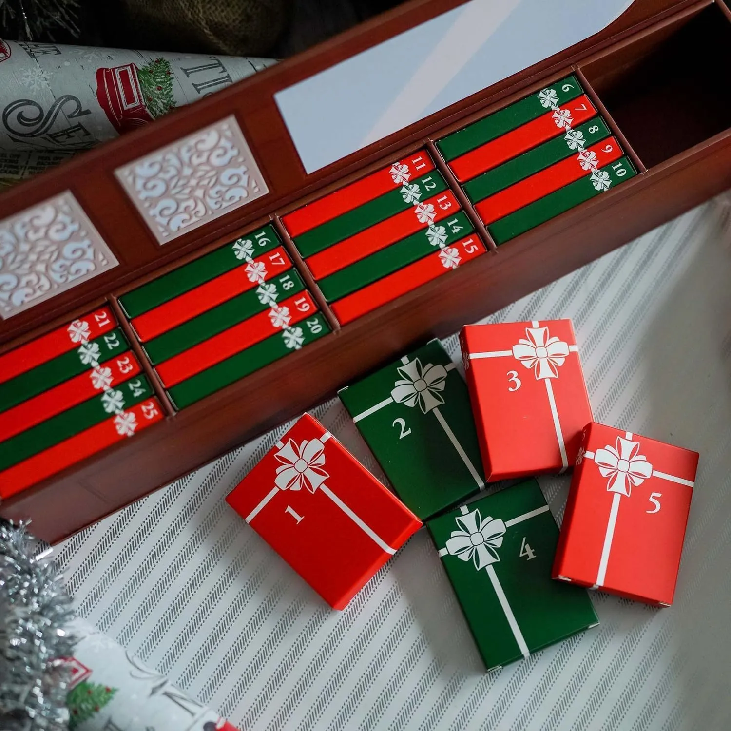 Numbered red and green sleeves inside the brown mini book advent calendar