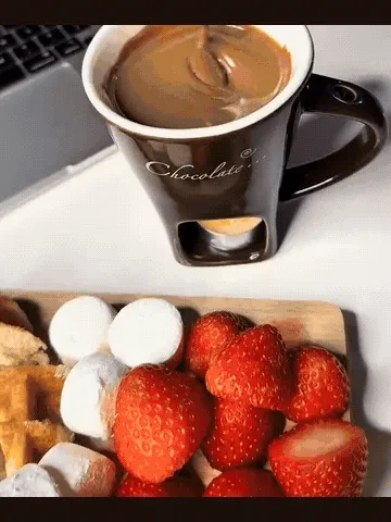 Chocolate melting in a tealight-warmed fondue mug and used for dipping treats