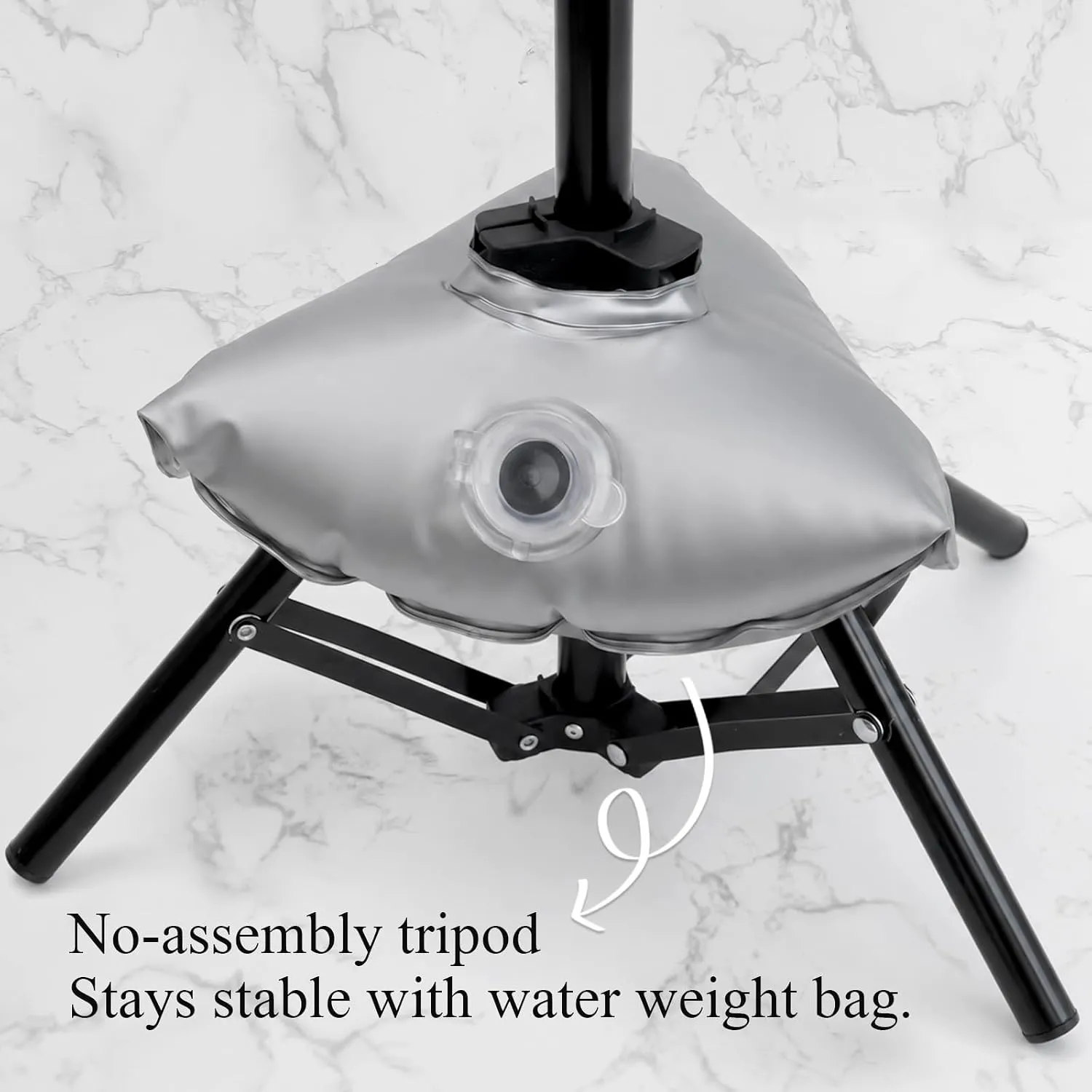 Silver water-weight bag fitted over a black fold-out tripod stand