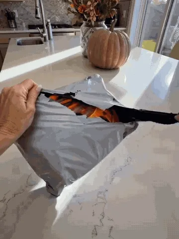 Pumpkin treat bags being opened, filled with candy, prepared in rows, and carried by trick-or-treaters