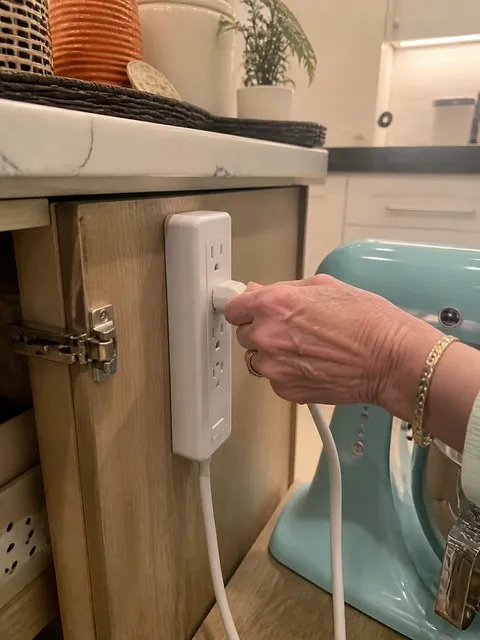 Neatly mounted power strip in a kitchen
