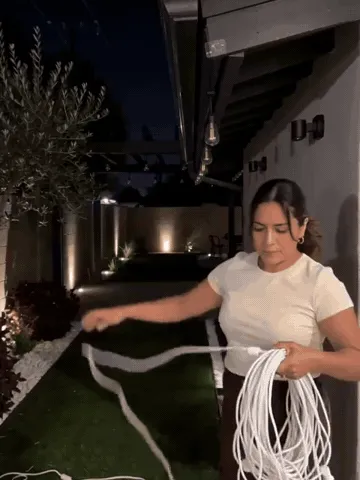 Outdoor string lights being arranged around a patio