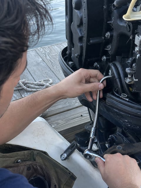 Flexible socket extension used inside an outboard motor