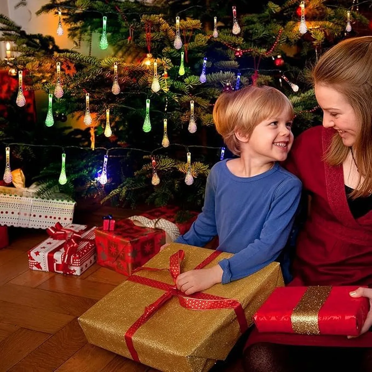 Family enjoying multicolor waterdrop lights on a holiday tree