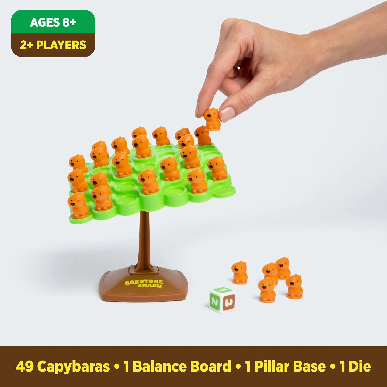 Capybara balance game with orange pieces, green board, pedestal, and die