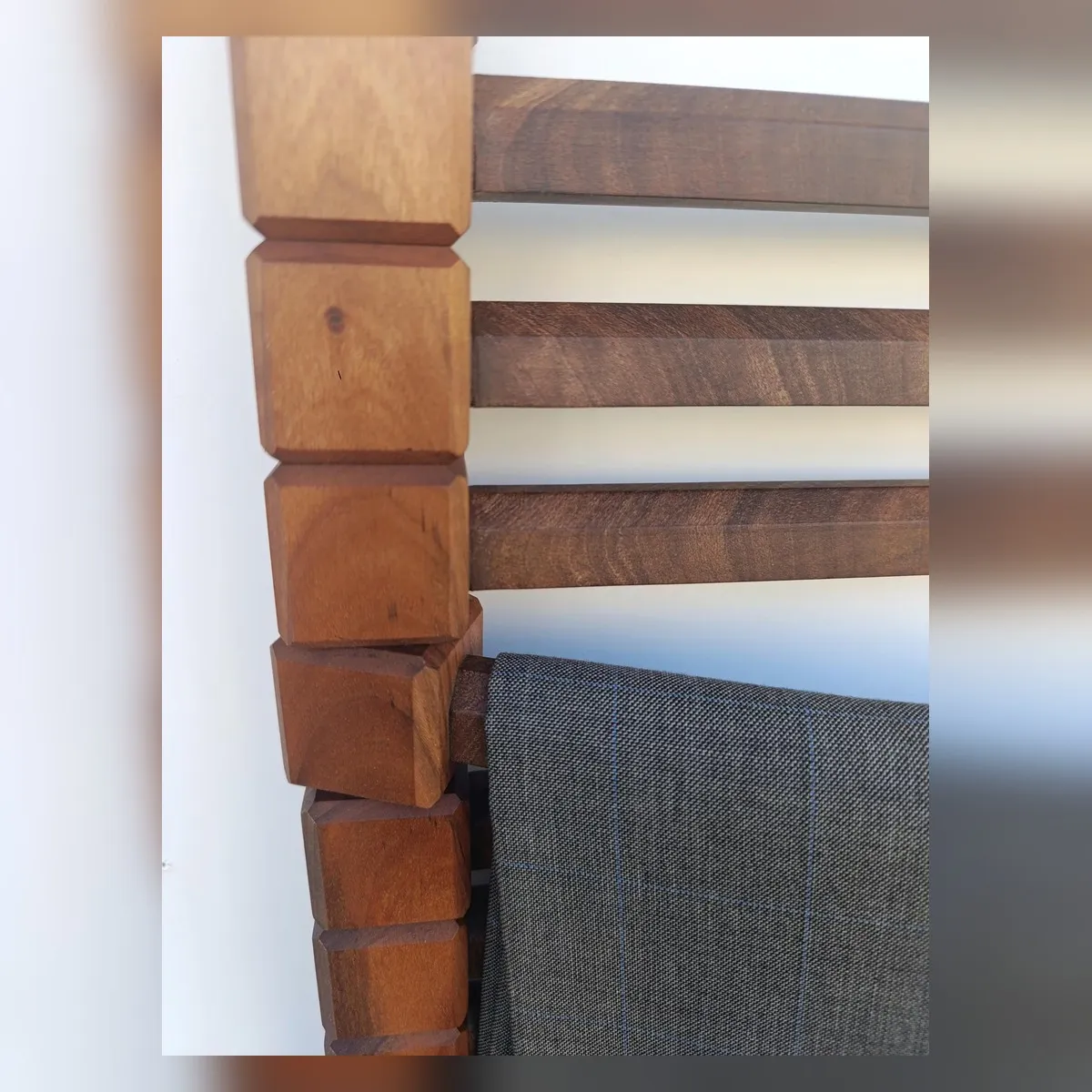 Close view of the natural wood grain and segmented pivot blocks