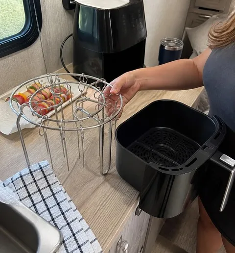Skewer rack beside an air fryer in an RV kitchen