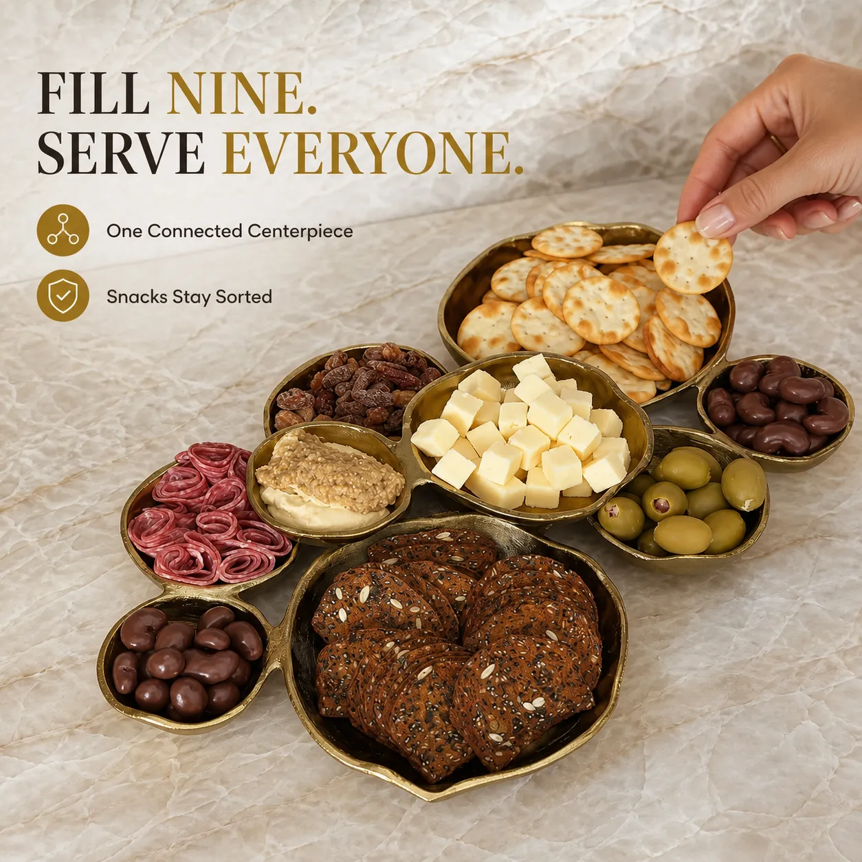 Connected gold nine-compartment serving centerpiece filled with party snacks