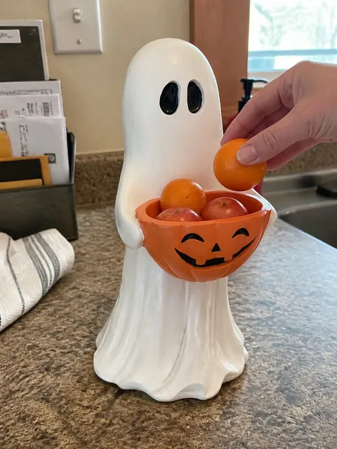 Ghost pumpkin bowl used for small fruit on a kitchen counter