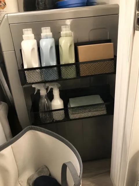 Laundry supplies stored in two magnetic mesh racks