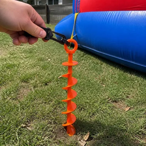 Ground anchor connected to a backyard inflatable