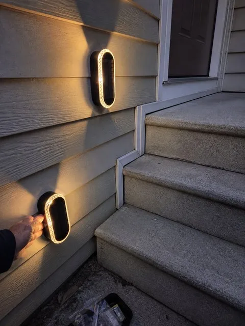 Outdoor solar wall lights in a customer's home setting