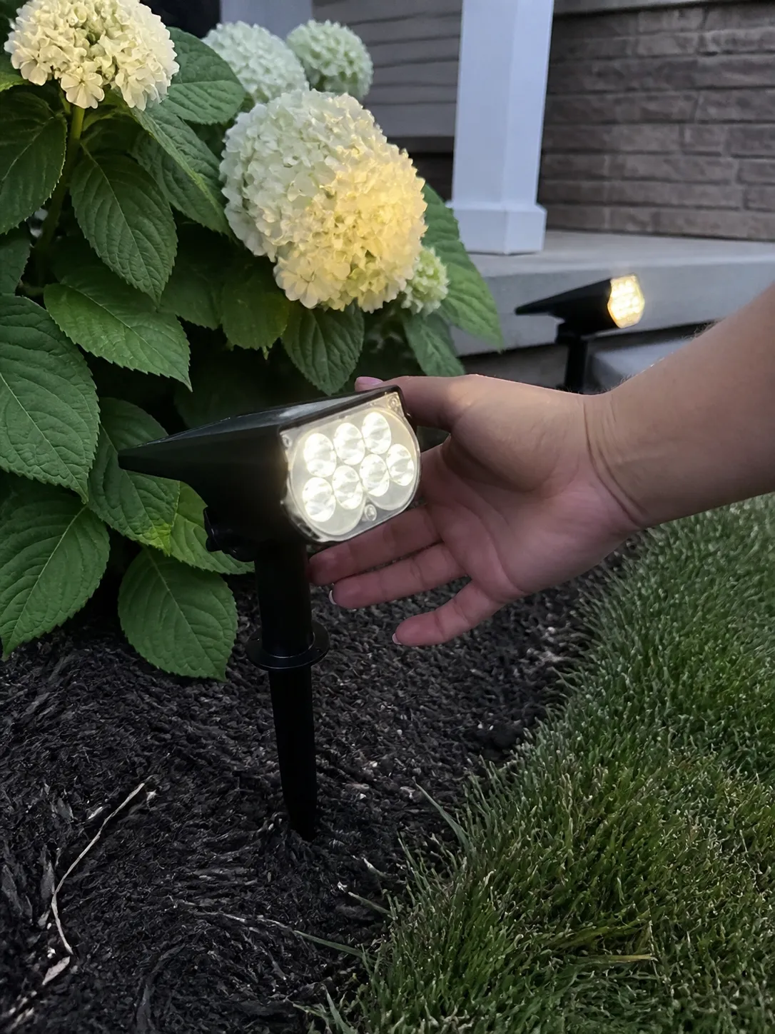 Customer adjusting solar spotlight