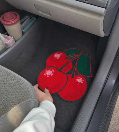 Casual customer-style photo of the cherry mat in a car