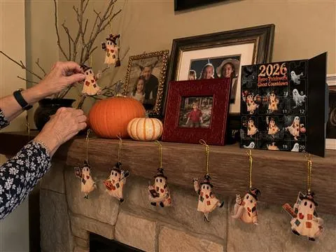 Flat patchwork ghost ornaments displayed across a home mantel