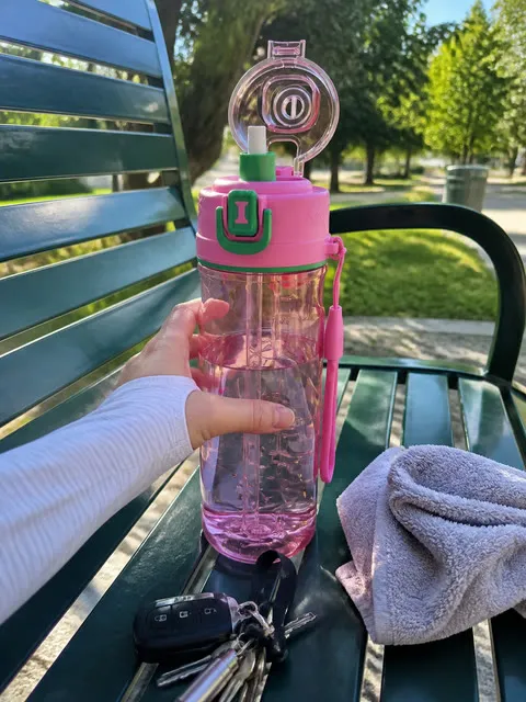 Misting bottle on a park bench after a run