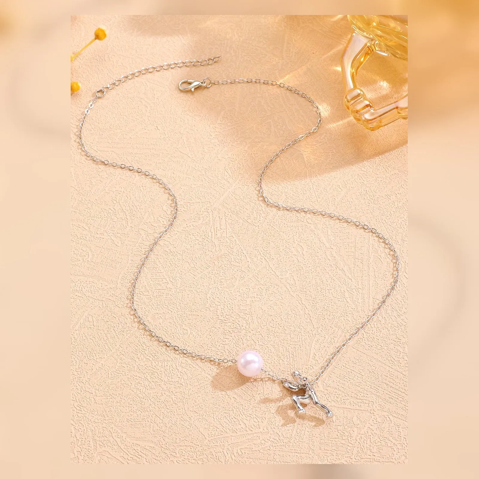 Complete pearl pusher necklace with chain and clasp visible