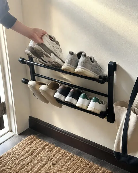 Wall shoe rack in a compact apartment entry