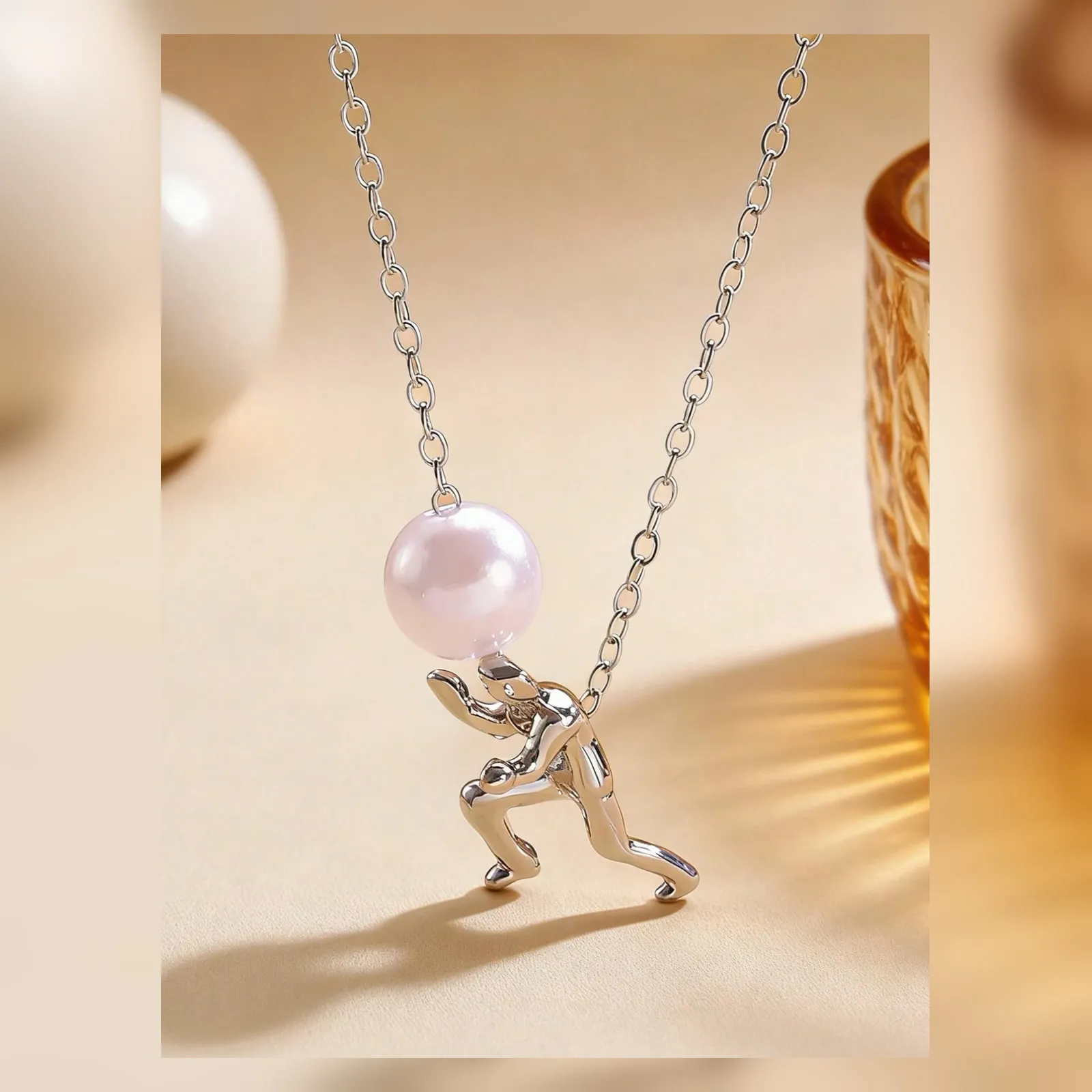 Close view of the figure pushing a single pearl