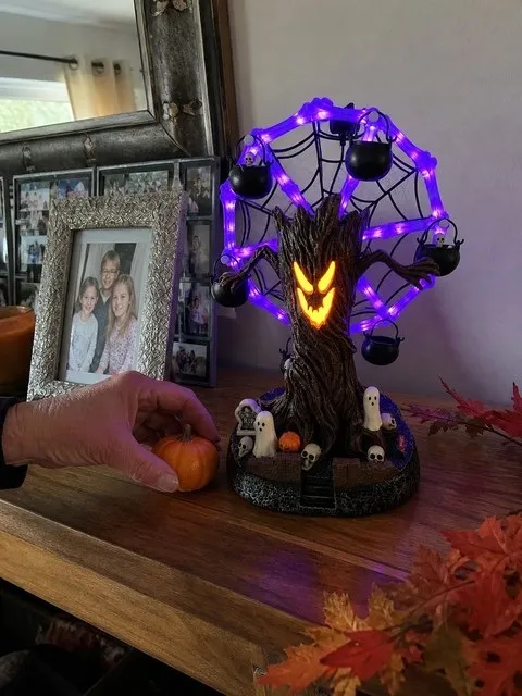 Haunted tree Ferris wheel on a family sideboard with autumn decorations