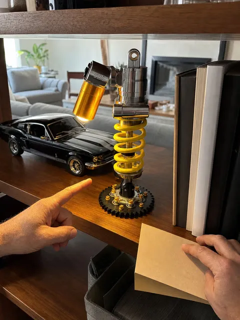 Shock absorber lamp displayed with books and a model car