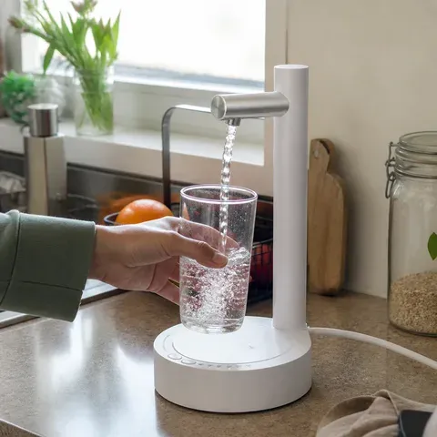 Customer using white dispenser in kitchen