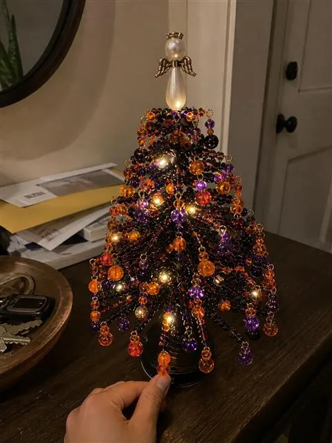 Halloween beaded tree glowing on an entryway console