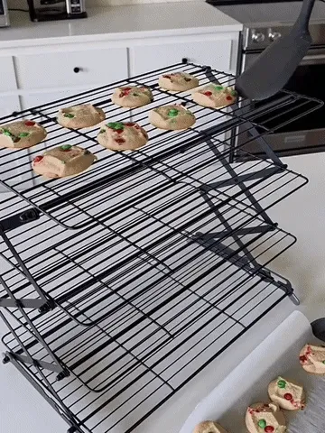 Three-tier cooling rack holding cookies before folding flat for storage