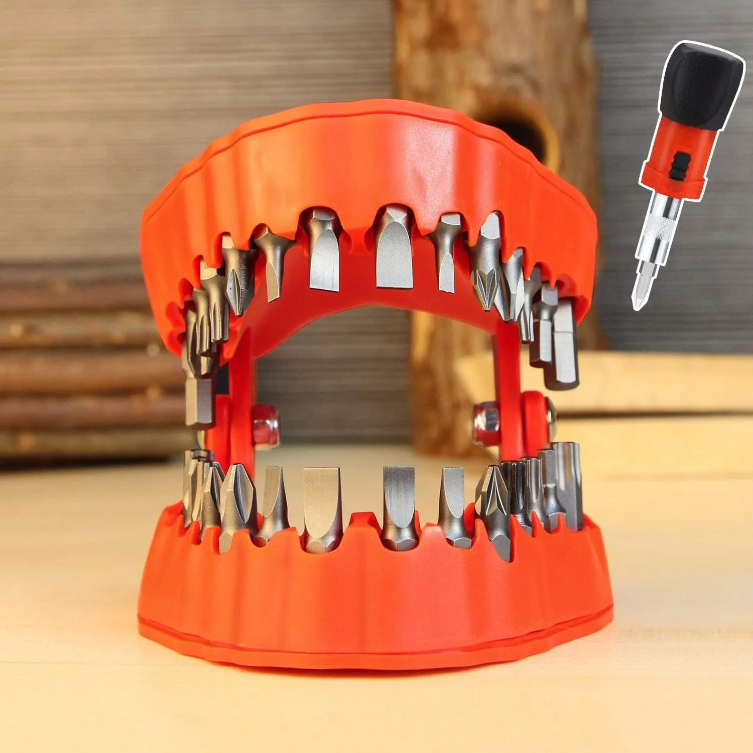 Red denture-shaped organizer holding screwdriver bits on a workbench