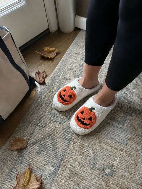 White pumpkin slippers worn in a fall entryway