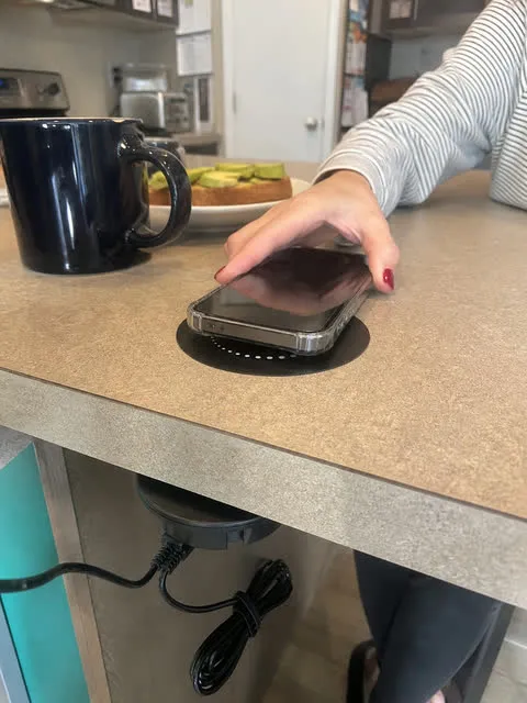 Phone charging at a kitchen breakfast counter