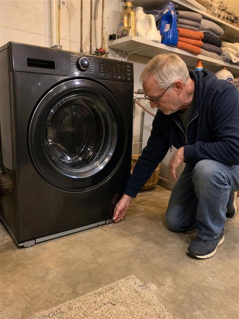 Checking the low support rail beneath a washer