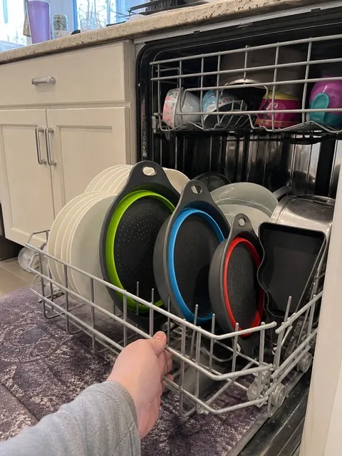 Three folded colanders arranged in a household dishwasher