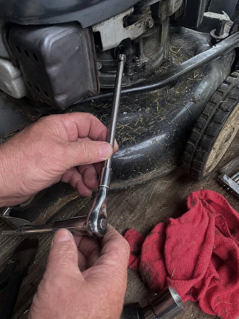 Flexible socket extension used beside a lawn mower engine